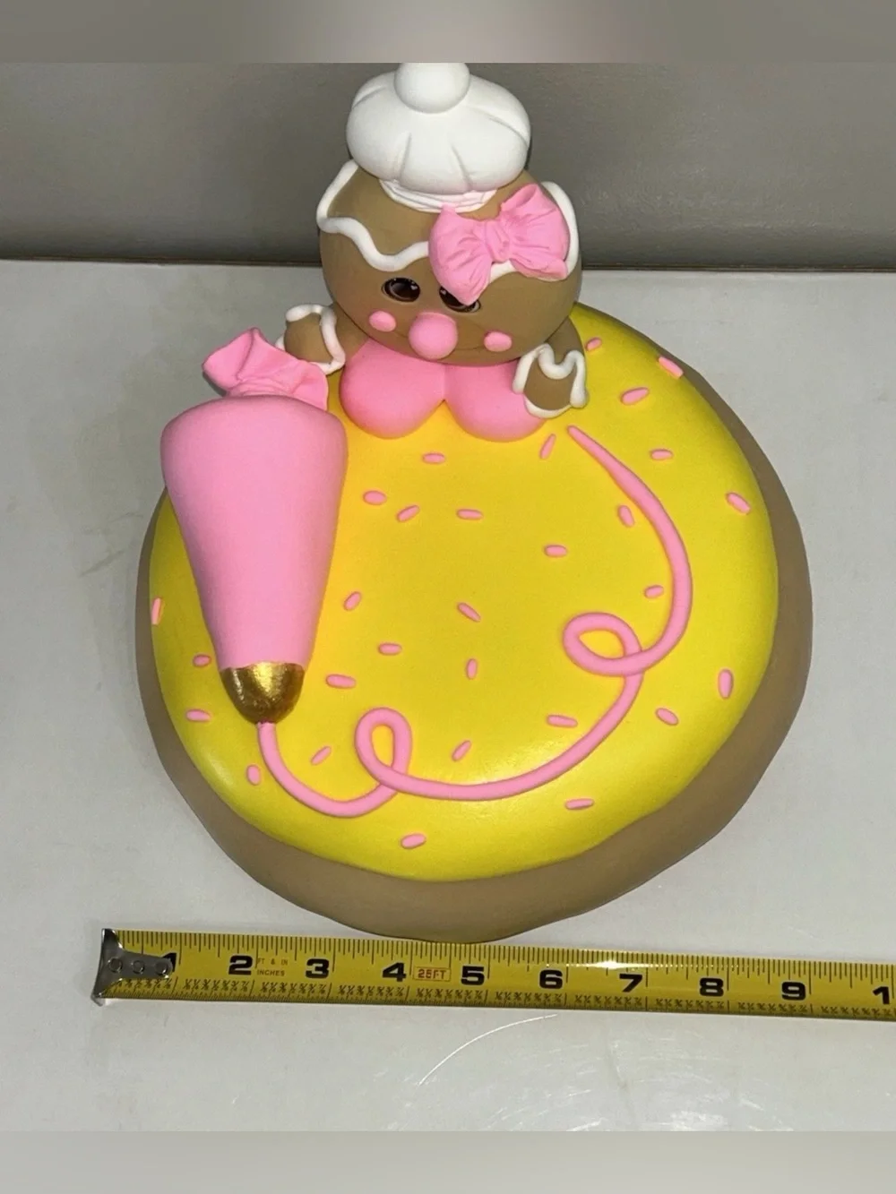 Whimsical Pink & Yellow Fake Gingerbread Baker on Giant Sugar Cookie Display